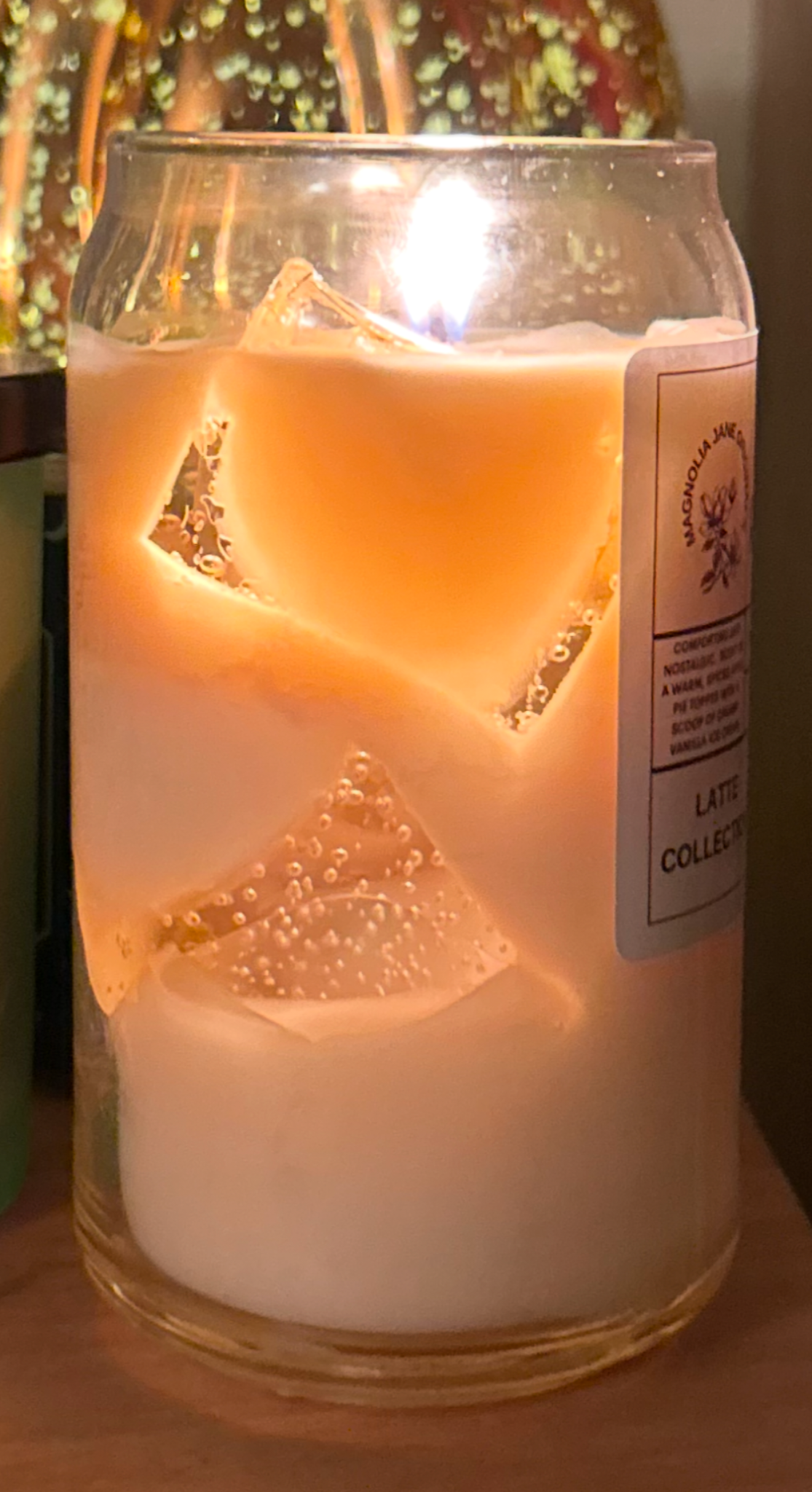What the latte candle looks like when it is lit, showing the glow of the gel wax cubes