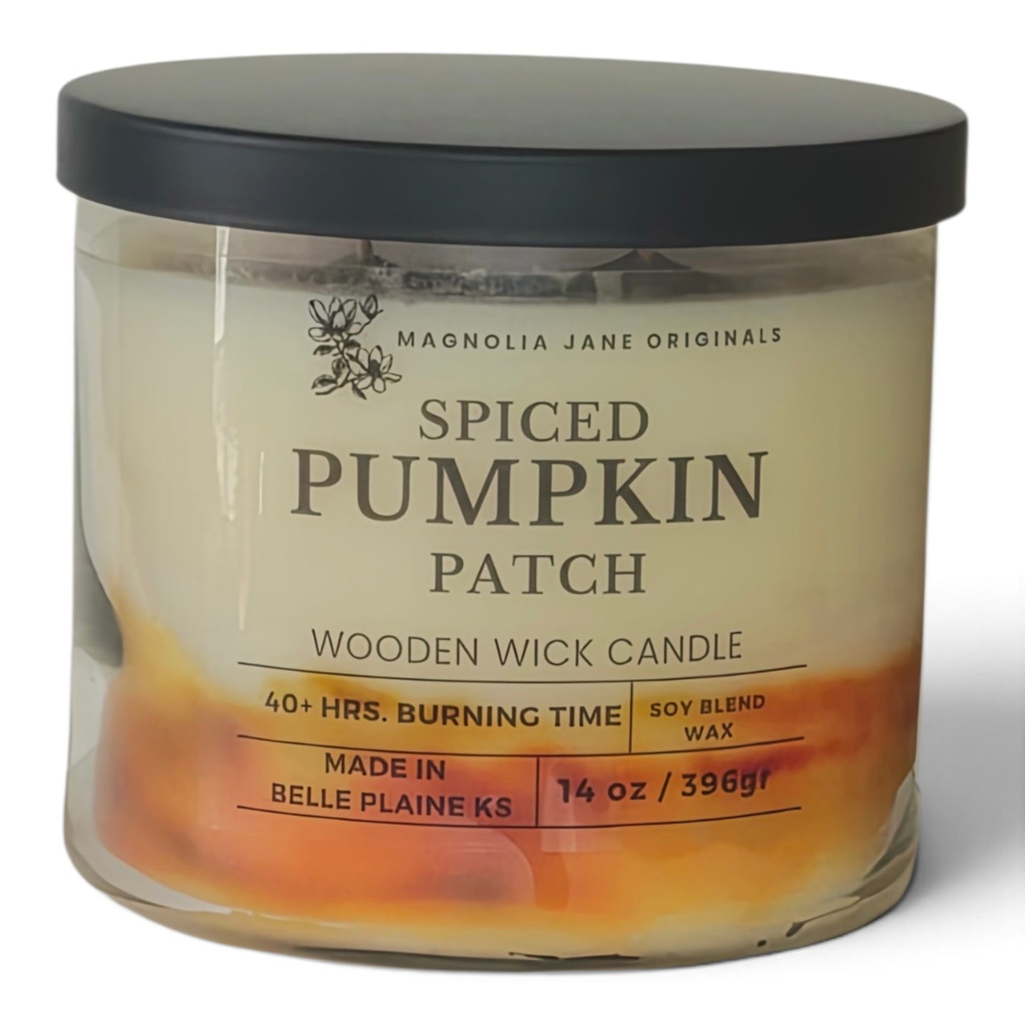 A 14 oz glass jar candle by Magnolia Jane Originals in the 'Spiced Pumpkin Patch' scent, featuring a black lid and a label with orange and yellow accents on a white background.