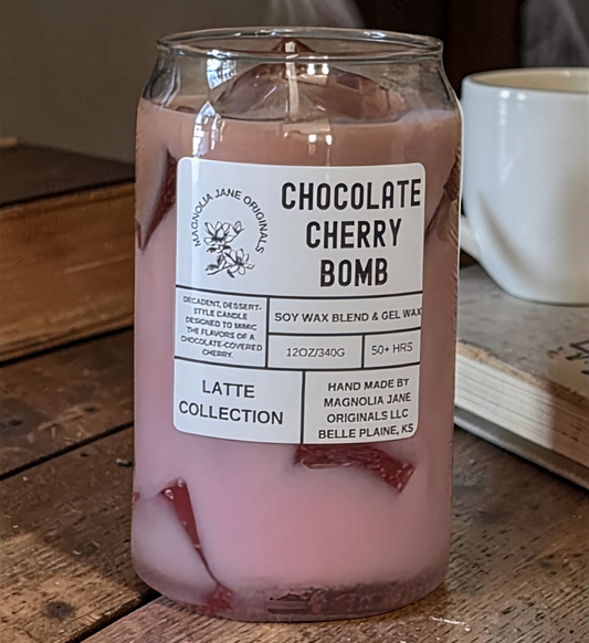 A tall glass with gel wax that appear to look like ice cubes.  The cubes glow when lit. The top third of the candle is a pale brown and the bottom 2/3 is a pale pink with a blend where they meet.