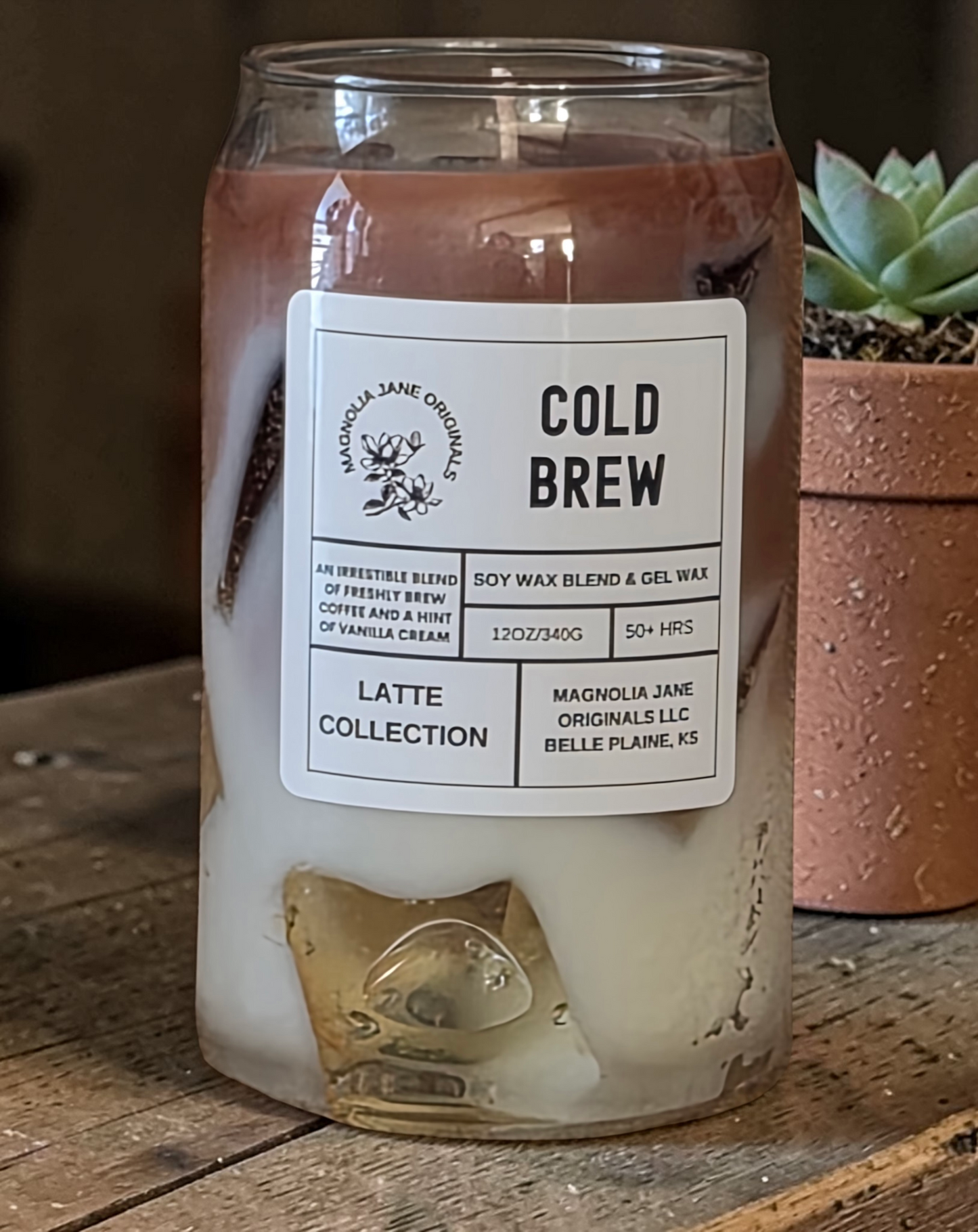 A tall glass with gel wax that appear to look like ice cubes.  The cubes glow when lit. The top third of the candle is a medium to dark brown and the bottom 2/3 is a creamy white with a blend where they meet.