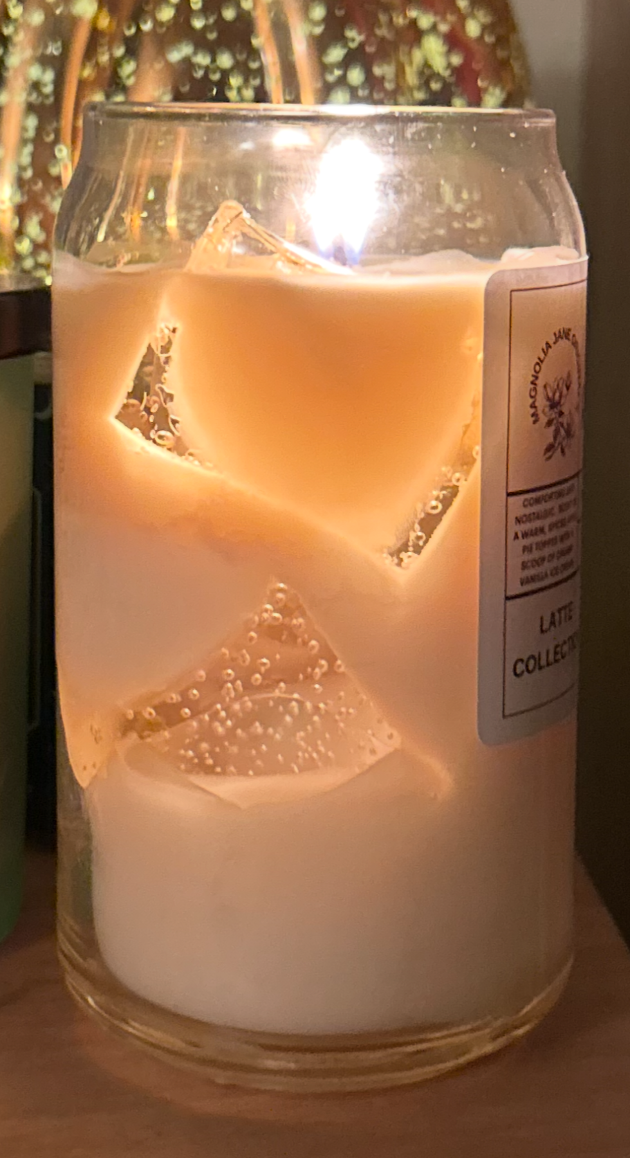 What the latte candle looks like when it is lit, showing the glow of the gel wax cubes