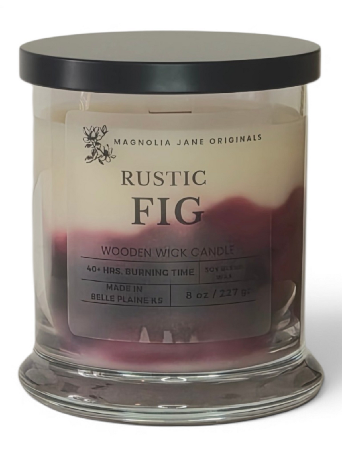 Magnolia Jane Originals Rustic Fig wooden wick candle in a clear glass jar with a black lid, showing a cream and deep burgundy wax layer.
