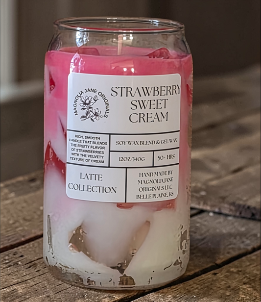 A tall glass with gel wax that appear to look like ice cubes.  The cubes glow when lit. The top third of the candle is a pale rose color and the bottom 2/3 is a creamy white with a blend where they meet.