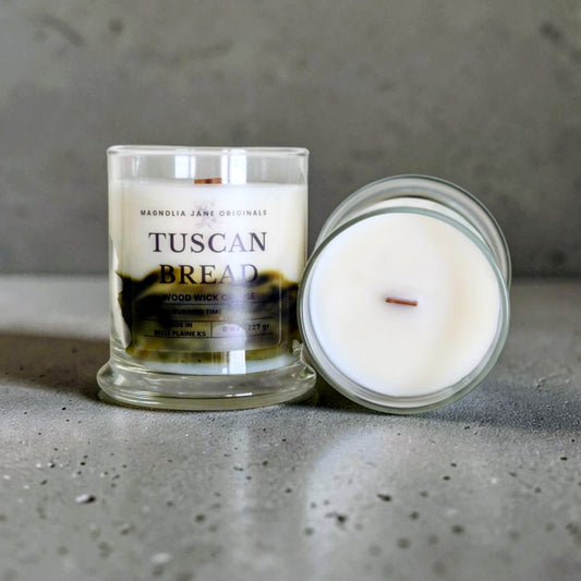 Tuscan Bread is a wooden wick candle that is a creamy white color with a swirl design on the lower half of the candle in brown & olive green